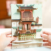 DIY Falling Sakura Book Nook Kit by Diokits - Chinese Influenced Art Being SHown By Person