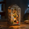 DIY Garden House Book Nook Kit by Diokits With The Lights Turned On In a Dim Environment