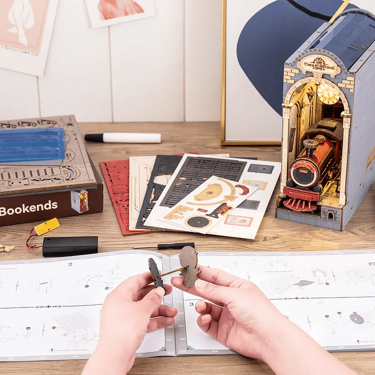 DIY Time Travel Book Nook Kit by Diokits Being Assembled By a Person With an Instruction Manual 