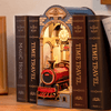 DIY Time Travel Book Nook Kit by Diokits in a Shelf With Lights On Shown as Decoration