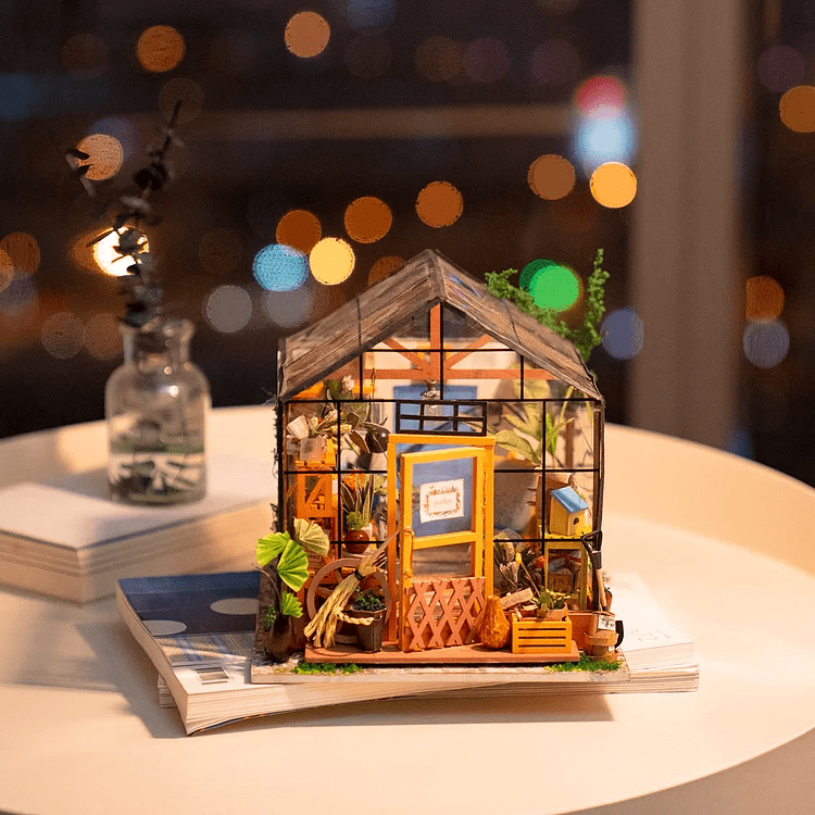 Cathy’s Flower House DIY Miniature House Kit by Diokits Shown As Decoration On Top Of Table With Windows Background